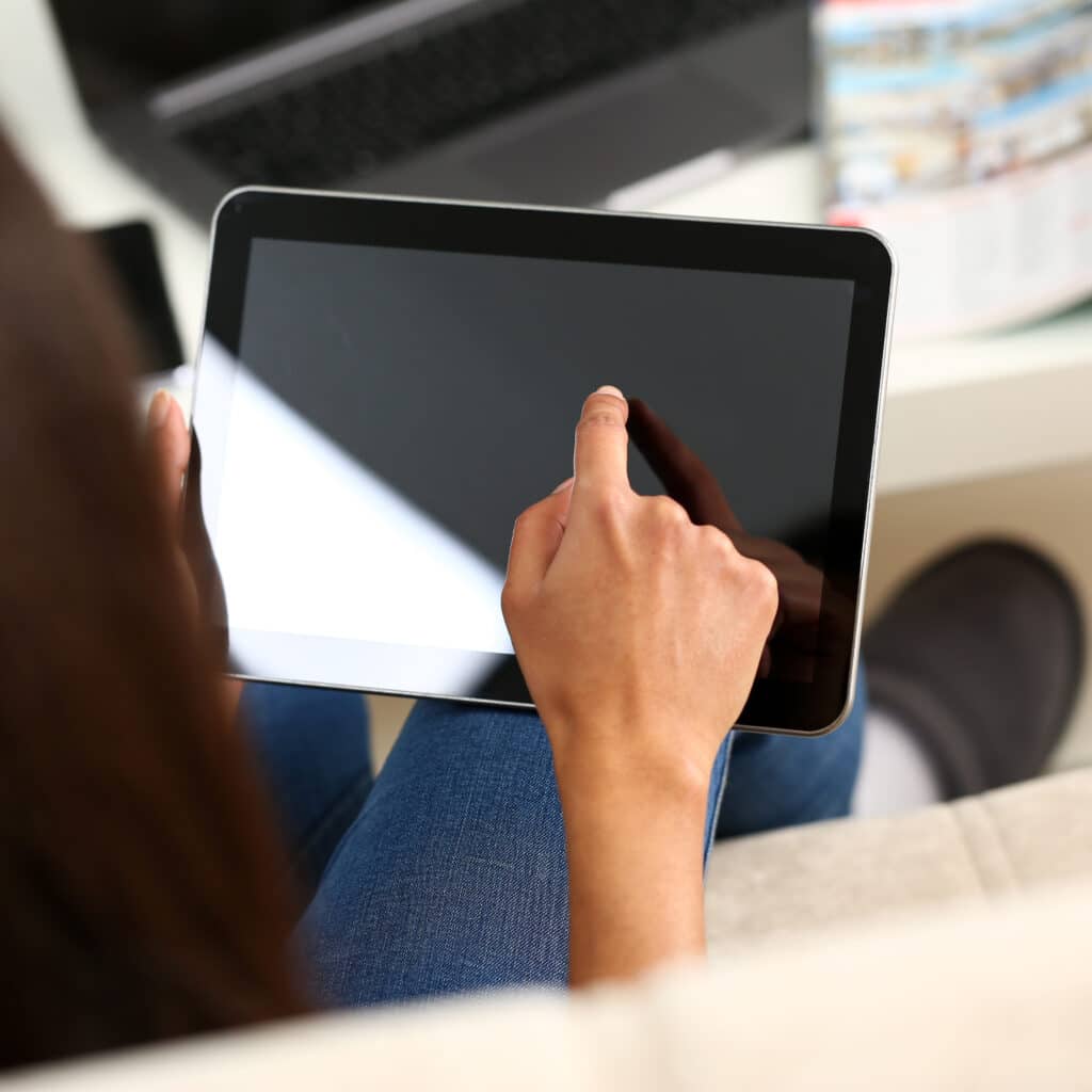female hand holds tablet home setting while