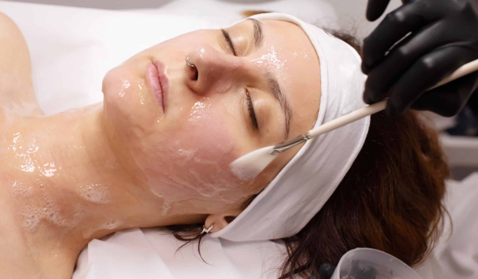cosmetologist-applying-chemical-peel-product-client-s-face-salon
